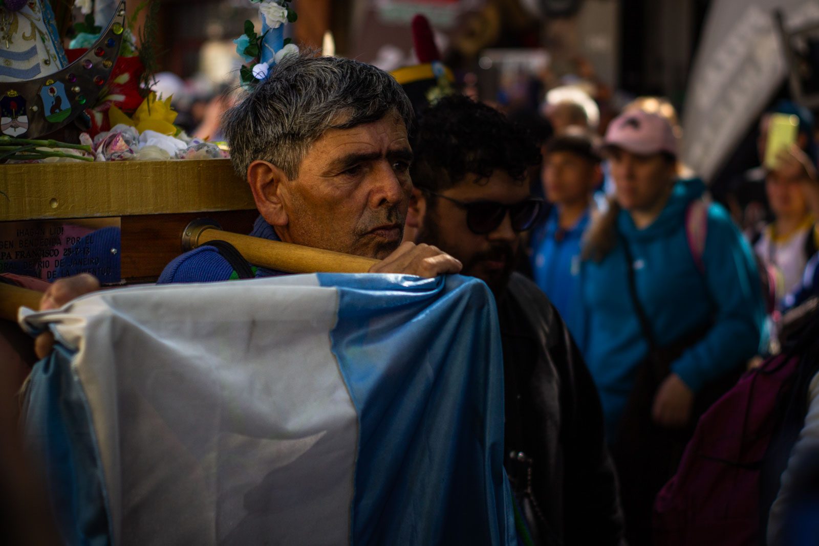 A pilgrim carries an image of the Virgin of Luján wrapped in an Argentine flag at the Saint Cajetan Sanctuary in the Liniers neighborhood of Buenos Aires, Argentina, October 5, 2024.