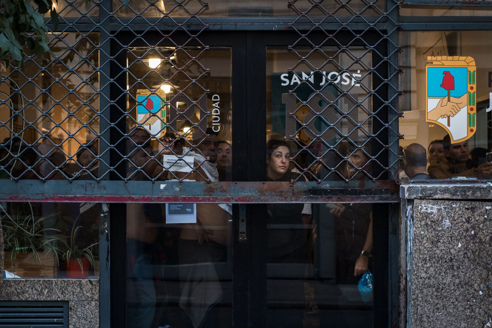 Un grupo de personas se resguarda en la sede del Partido Justicialista (PJ) durante la represión a la marcha en apoyo a los jubilados, en Buenos Aires, Argentina, el 12 de marzo de 2025.