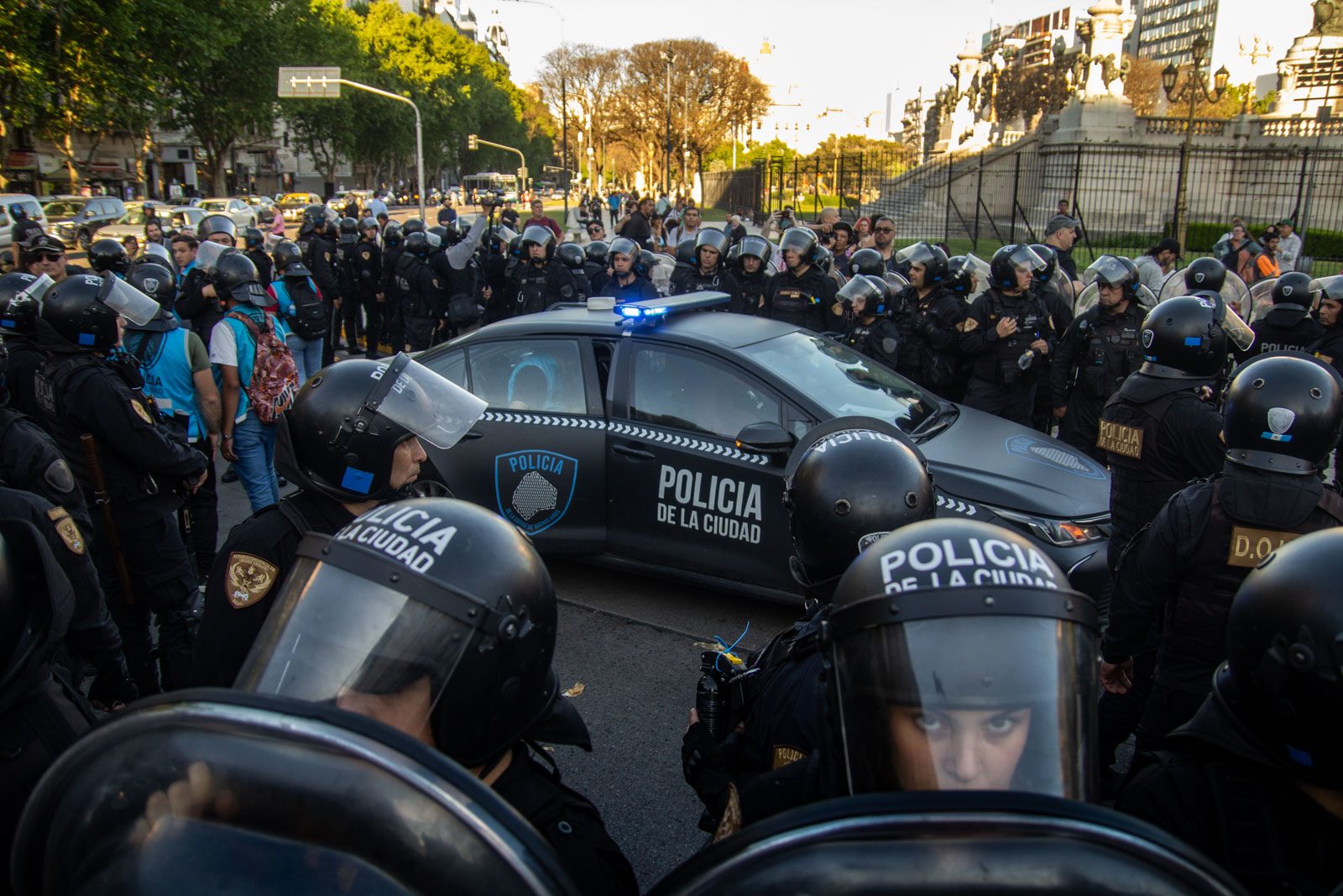 Un patrullero de la Policía de la Ciudad queda rodeado por efectivos al caer la tarde, durante la marcha de jubilados frente al Congreso Nacional, en Buenos Aires, Argentina, el 8 de octubre de 2025.